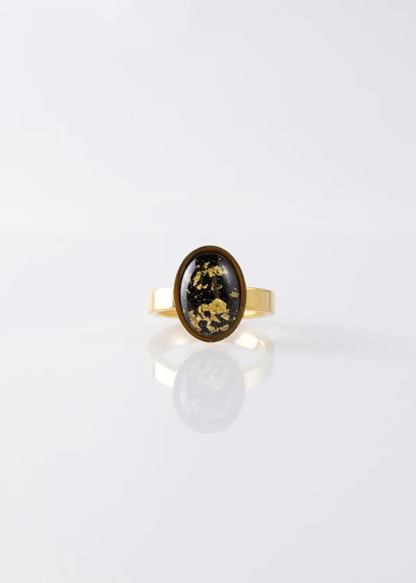 Oval ring with a black gold bezel
