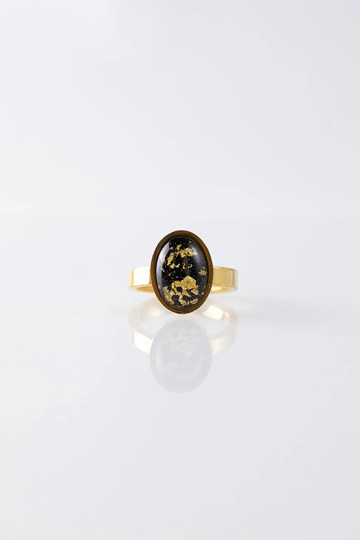 Oval ring with a black gold bezel