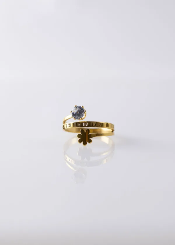 An open ring with a zircon stone and a rose with Latin numbers