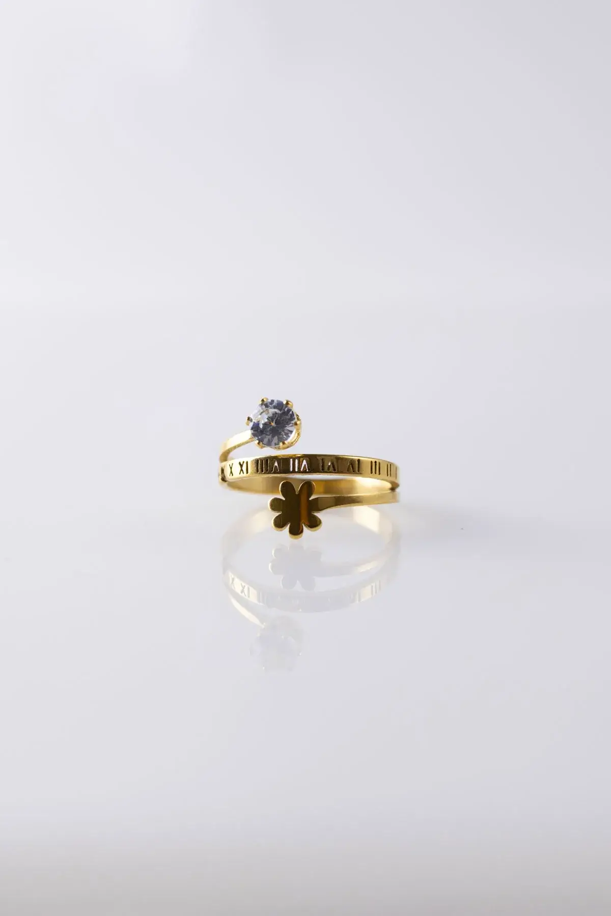 An open ring with a zircon stone and a rose with Latin numbers
