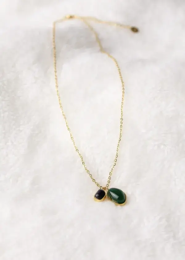 A chain of two bracelets with black and olive beads