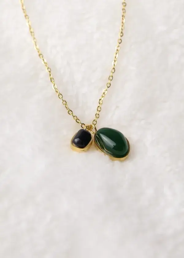 A chain of two bracelets with black and olive beads