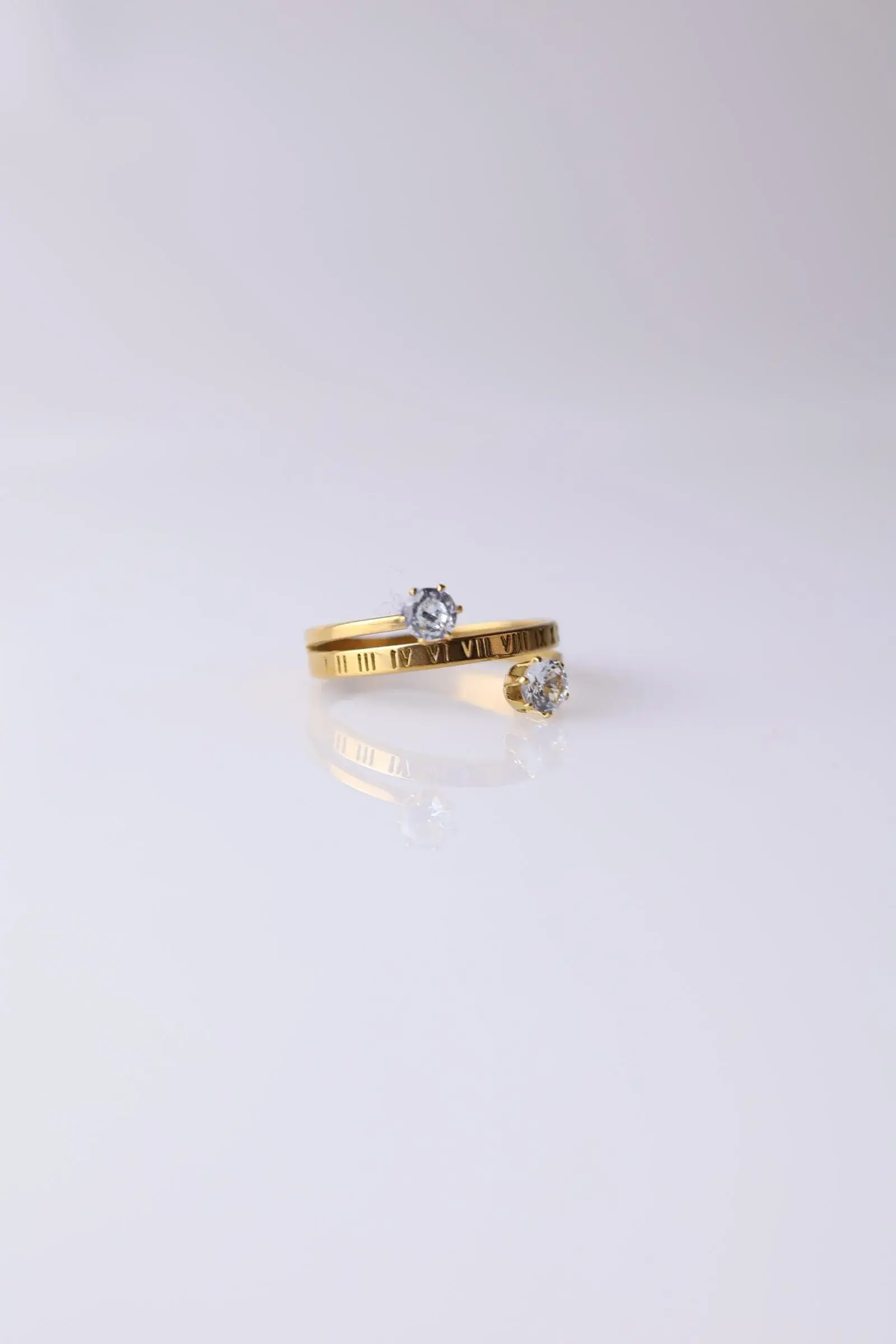 Open ring with Latin numbers and two zirconium lobes